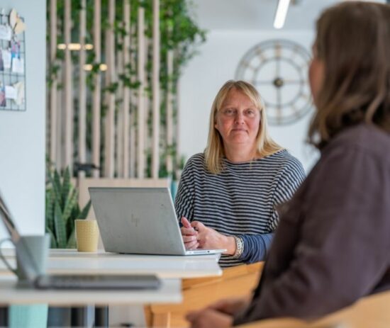 An image of two women talking