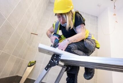 An image of a woman sawing