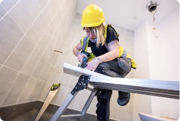 A woman using a drill.